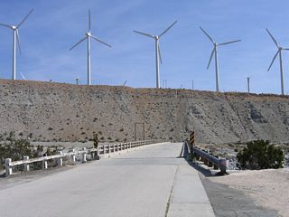 U.S. 60-70-99 used to cross this bridge over the Whitewater River. The Whitewater River drains from Mount San Gorgonio, and during the Winter and Spring months, water flows through from the high country down toward Palm Springs, the Coachella Valley, and the Salton Sea. Much of the old road standards still remain here, including the banked roadway and approach onto the bridge.