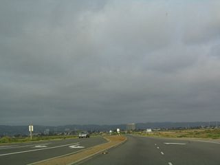 Doolittle Drive narrows to a two-lane facility as it skirts the airport property. California 61 leaves the city of Alameda and enters the city of Oakland.