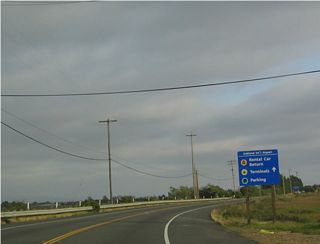 Southbound California 61 (Doolittle Drive) passes along the west shore of San Leandro Bay as it skirts the northeastern edge of the Oakland International Airport. The highway widens from two to four lanes upon reaching the airport entrances.