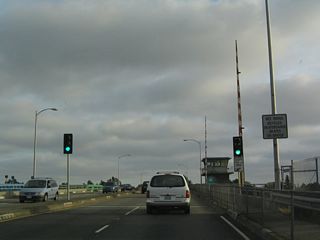 Southbound California 61 (Otis Drive) approaches the San Leandro Channel Drawbridge.