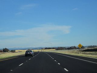 Southbound California 65 travels almost due east briefly after Nelson Lane, hence why the Sierra Nevada comes into view in the distance. The freeway will then turn southeast to rejoin the original California 65 (Historic U.S. 99E) alignment, then proceed toward Roseville.