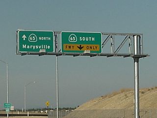 Reflective overhead signs for California 65 are posted on the collector distributor lanes from Interstate 80.