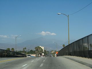 Cresting over the freeway, California 66 ends on the far side of the bridge over Interstate 215.