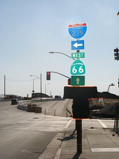 Traveling west along Fifth Street in San Bernardino, the first reassurance shield along California 66 west is this shield assembly prior to the Interstate 215 crossing. Reconstruction of the bridge over Interstate 215 was underway at this time due to the expansion project along Interstate 215 through San Bernardino. This intersection marks the eastern terminus of California 66.