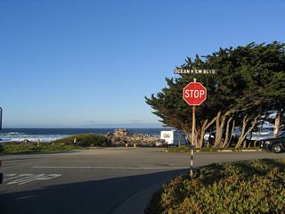 Here is another view of northbound Asilomar Avenue at Ocean View Boulevard. Turn left to Point Pinos and the turn to Sunset Drive south to Asilomar State Beach. Turn right to follow Ocean View Boulevard southeast to downtown Pacific Grove and downtown Monterey.