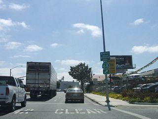 After departing U.S. 101, westbound California 68 (John Street) crosses the Union Pacific Railroad tracks and approaches downtown Salinas. The first major intersection (seen in the distance ahead) is with U.S. 101 Business (Front Street) north and U.S. 101 Business (Abbott Street) south. Continue west on California 68 to downtown Salinas and the Steinbeck Center.