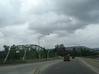 Parallel to the modern, 1980s-era California 70 Business/Table Mountain Bridge is the original steel through-truss bridge (Upper Thermalito Bridge) that was built in 1907 and served as the primary river crossing until the modern bridge opened. The original bridge remains in use as a bridge for pedestrians and bicyclists.