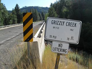 Notable along the westbound direction of Rocky Point Road is this remnant bridge identification sign for Route 70 as it crosses over Grizzly Creek.