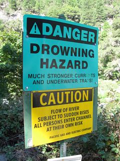 While beautiful and tempting to swim on a hot summer day, the North Fork of the Feather River flows fast between the hydroelectric facilities operated by Pacific Gas & Electric. As a result, warning signs advise people to stay out of the water. This particular sign is located at the Shady Rest Day Use Area off California 70 near the Arch Rock Tunnel.