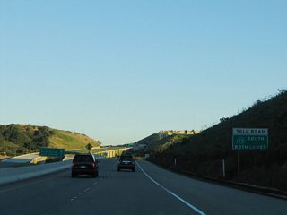 A two-lane, one-way roadway connects California 133 (Laguna Canyon Road) with California 73 (San Joaquin Hills Transportation Corridor) south. This view looks at this one-way frontage road between California 133 and the intersection with El Toro Road (CR S-18).