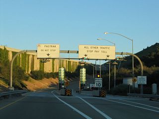 The toll plaza awaits along the on-ramp to California 73 south from the frontage road.