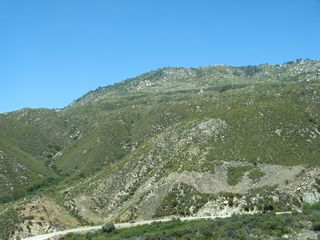 A sweeping curve carries California 74 above the South Fork of the San Jacinto River and below the mountains.