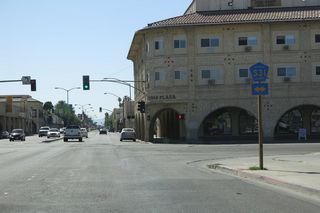 Several blocks west, Main Street meets Eighth Street at this traffic signal. Turn left for Imperial County S-31 south to El Centro or right for Imperial County S-31 and Old Highway 111 north to California 111 north to Calipatria. Both California 78 and California 111 shields were posted here until 2012; now only CR S-31 shields remain.