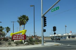 Eastbound Wake Avenue approaches California 86 (Fourth Street) in southern El Centro, just south of the interchange with Interstate 8. Turn left for California 86 north to Interstate 8 and downtown El Centro or turn right for California 86 south to Heber and Calexico. Notably, the street guide signs hanging from the traffic signal mast arms contain the state route marker as well as the road name.