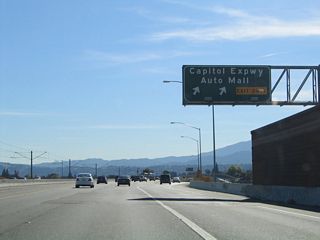 Two lanes depart from southbound SR 87 (Guadalupe Parkway) at Exit 1 D for Santa Clara County Route G-21 (Capitol Expressway) and Auto Mall.
