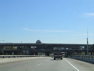 California 87 passes under the Interstate 280 freeway. Light rail joins California 87 in the median; the light rail will remain in the median until the California 85 interchange.