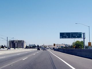 The signage for Alma Avenue changed between 2004 and 2007 to incorporate a collector distributor lane arrangement and an exit number.