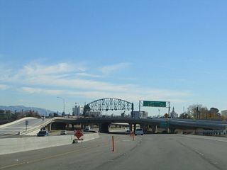 The interchange between California 87 (Guadalupe Parkway) and Exit 7, Taylor Street is a single point urban interchange (SPUI). The tall truss structure across the overpass supports the traffic signals needed for this single point intersection.