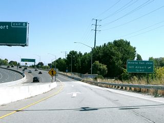 Upon reaching ground level, the two-lane flyover ramp reduces to one lane and merges onto the ramp from U.S. 101 south to California 87 south. The rest of the overhead sign can be seen in the next photobox.