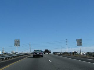 A pair of begin freeway signs flank the eastbound lanes of California 90 (Marina Freeway).