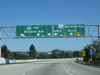 The left three lanes continue west on California 90, while the right lane becomes exit only for Interstate 405 (San Diego Freeway) north and south.