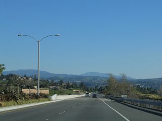 The Kellogg Drive diamond interchange was constructed in 1962 as part of larger plans to construct a freeway along the California 90 corridor. That plan is all but dead, with the parkway segment the only remanants of the freeway proposal left in Orange County.