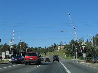 As westbound California 90 (Imperial Highway) crosses over the Santa Ana River, we approach a railroad crossing followed by a signalized intersection with Esperanza Road east and Orangethorpe Avenue west. This intersection was converted into a grade-separated interchange with a traffic signal between the two roadways in the late 2000s.