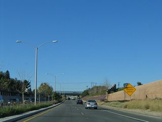 Approaching the Lakeview Avenue overpass, a warning sign advises of the pending end of the parkway and upcoming traffic signal with Yorba Linda Boulevard.