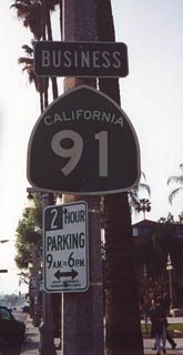 California 91 Business through Riverside follows Magnolia Avenue, then turns back to California 91 via Mission Boulevard.  This picture shows a California 91 Business shield in front of the historic Mission Inn in downtown Riverside. This designation appears to have been decommissioned, as all signs for the business route were gone by 2008.