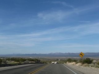 The Dead Mountains spread along the northern horizon as U.S. 95 lowers from Parker Junction to Airport Road east of Needles Airport (EED).