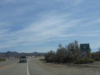 U.S. 95/Historic U.S. 66 cross Crestview Wash south leading into the diamond interchange along Interstate 40 at Exit 133.