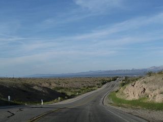 U.S. 95 drops below 900 feet in elevation across a series of hills south of Parker Junction.