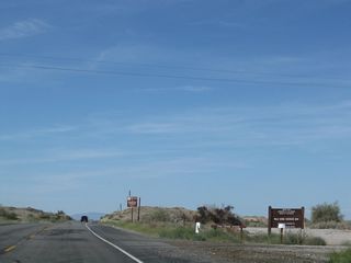 Northbound U.S. 95 approaches the turnoff for the Palo Verde Diversion Dam. The dam holds back water as part of an elaborate river management plan for the Colorado River south of Lake Mead. In addition to flood control, the dam is also part of a water diversion network. Water is diverted from the river for agricultural and urban uses via aqueducts that send water both west toward coastal Southern California and east toward central Arizona (Phoenix).
