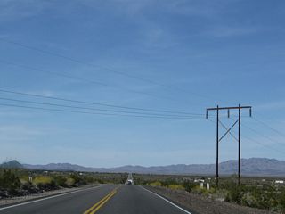 A high-voltage power transmission line crosses over U.S. 95 near the Agnes Wilson Road intersection. To the west of U.S. 95 are the Riverside Mountains.