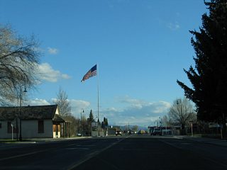 Main Street leads U.S. 97 south through the Dorris business district. Rising to a height of 200 feet by City Hall is the tallest flagpole west of the Mississippi.