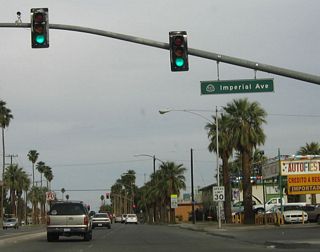 This close-up of the mast arm traffic signal shows the detail of the California 111 shield on the street name indicator. In Caltrans District 11, this type of signage at a signalized intersection is standard.