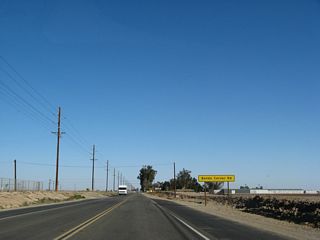 Eastbound California 98 enters Bonds Corner, a small community located at the intersection of California 98 and Bonds Corner Road. From here, Bonds Corner Road travels north to Holtville.