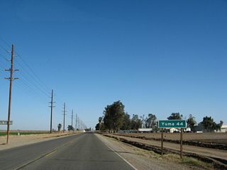 A mileage sign for the city of Yuma, Arizona, is posted on eastbound California 98 after leaving Bonds Corner. California 98 will rejoin Interstate 8 at Exit 143, and Interstate 8 provides the connection to Winterhaven and Yuma.
