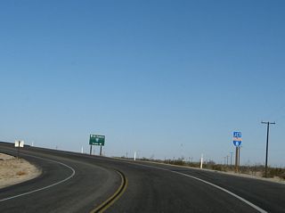 Eastbound California 98 approaches Interstate 8. This trailblazer for Interstate 8 features a "junction (JCT)" banner and has a 1979 specification Interstate 8 shield.