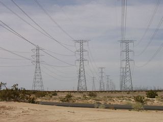 These power lines are west of Calexico, looking north toward the large Imperial Valley substation, where they merge into the east-west 500 kV line. The power lines originate in Mexico and bring energy generated by two power plants into the United States: The easternmost line brings power from the Termoelectrica de Mexicali Power Plant, and the middle line brings power from the La Rosita Power Plant. After a series of legal skirmishes, the power lines were granted approval by the U.S. Department of Energy in 2004.�