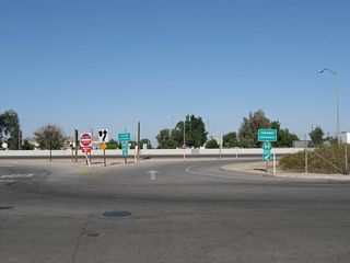 This freeway entrance shield assembly for California 99 is posted at the intersection of Fremont Street and Ninth Avenue in Delano. Traffic on California 155 west must use Fremont Street to connect to California 99 north.