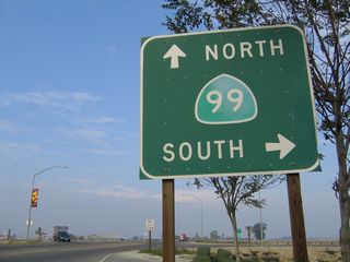 Traveling east on Winton Avenue in Livingston, this sign advises a right turn for California 99 south to Merced or straight ahead for California 99 north to Modesto. The freeway entrance shield assemblies are posted on the connection from Winton Avenue east to California 99 south.