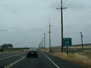 As evidenced by this sign, northbound California 99 merges with eastbound California 162. California 99 and California 162 will travel north together briefly, then separate. On the east side of California 99 is a levee that protects and separates the highway from the Thermalito Afterbay, a large body of water that exists downriver from Oroville Dam. Together with Lake Oroville, the Thermalito Afterbay and Forebay complex are part of the headwaters of the massive California State Water Project, which transports water from Northern California south to Southern California via the California Aqueduct (a portion of which is visible from Interstate 5 in the San Joaquin Valley).