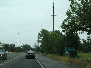 Although California 99 avoids downtown Biggs, this traffic signal connects California 99 to B Street west to Biggs and Biggs East Highway east to East Biggs. The city of Biggs "Where the People Own the Water and Power" and "The Heart of Rice Country" had a population of 1,707 as of the 2010 Census and sits at an elevation of 98 feet. Biggs was incorporated on June 26, 1903, and agriculture is the primary economic driver. Downtown Biggs is located on B Street between Fifth and Seventh Streets west of here. California 99 bypasses Biggs to the east, effectively splitting Biggs from nearby East Biggs.