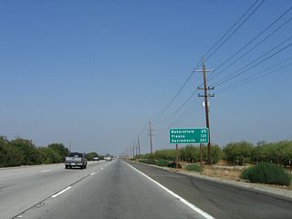 This mileage sign along California 99 (Golden State Highway) north provides the distance for three of the major cities along its route: Bakersfield (25 miles), Fresno (131 miles), and the control city, Sacramento (301 miles). The older sign (in the 2004 picture) featured kilometer distances to the same areas; the metric conversion was removed when the sign was replaced by 2006.