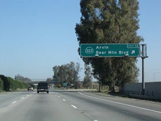 Northbound California 99 meets Exit 13, California 223 (Bear Mountain Boulevard). California 223 leads east to Arvin and ultimately California 58 near Caliente, and it also heads west to meet Interstate 5 at Exit 239.