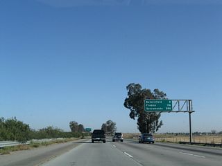 This mileage sign along California 99 (Golden State Highway) north provides the distance for three of the major cities along its route: Bakersfield (eight miles), Fresno (116 miles), and Sacramento (286 miles). This sign is positioned on an overhead gantry, which is unusual in California for this type of sign. Even though the overhead signs at the split from Interstate 5 listed California 99's control city as Fresno, it becomes Sacramento almost immediately. There is a negligible difference in the distance with either route to Sacramento - both routes are just about 295-300 miles from Wheeler Ridge to Sacramento.
