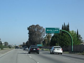 The next exit along northbound is Exit 21, White Lane (one mile). This sign was replaced with an exit number sign by 2009.