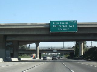 The next exit along northbound is Exit 25, California Avenue, which travels east toward the Bakersfield Civic Center and west to Stockdale Highway. California Avenue leads east into downtown Bakersfield, passing by Camelot Park, the railroad yards (to the north), and Bakersfield High School before meeting California 99 Business and California 204/Union Avenue.