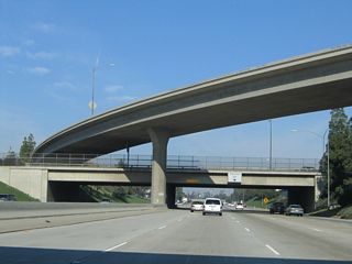 The flyover ramp from southbound California 99 to eastbound California 58 crosses the freeway here. Since the right lane becomes exit-only, trucks are advised to remain in the number three lane.